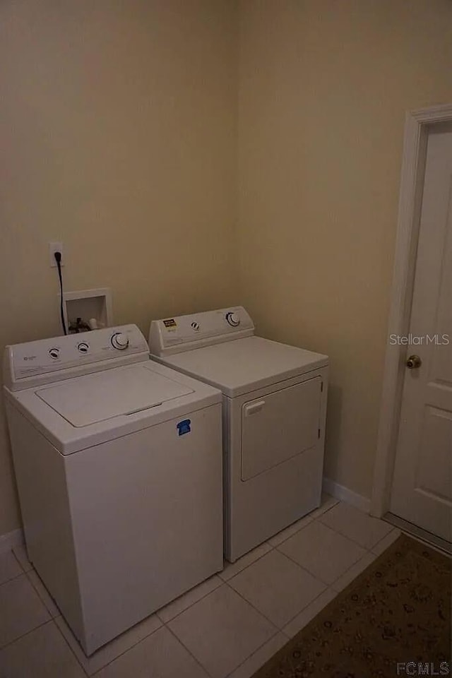 37 Ethan Allen Dr, Palm Coast, FL 32164 - laundry area with independent washer and dryer and light tile patterned flooring