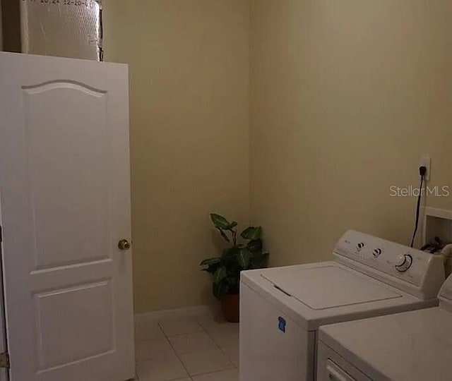 37 Ethan Allen Dr, Palm Coast, FL 32164 - washroom with washing machine and clothes dryer and light tile patterned floors