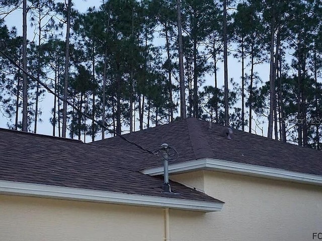 37 Ethan Allen Dr, Palm Coast, FL 32164 - exterior view of a shingled roof and stucco siding