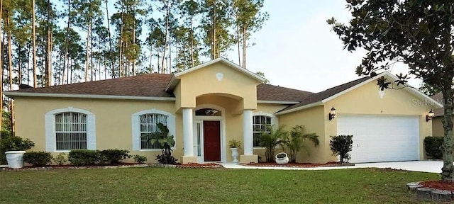 37 Ethan Allen Dr, Palm Coast, FL 32164 - view of front of home featuring a front yard, a garage, driveway, stucco siding, and a shingled roof