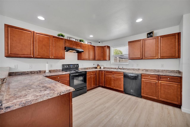 9 Summerset Ter, Casselberry, FL 32707 - kitchen featuring black appliances, under cabinet range hood, light wood-type flooring, brown cabinets, and recessed lighting