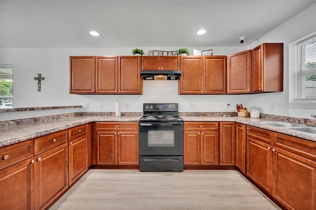 9 Summerset Ter, Casselberry, FL 32707 - kitchen with black range with electric cooktop, under cabinet range hood, light wood finished floors, brown cabinets, and recessed lighting