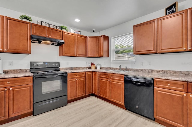 9 Summerset Ter, Casselberry, FL 32707 - kitchen featuring black appliances, under cabinet range hood, light wood-type flooring, brown cabinetry, and recessed lighting