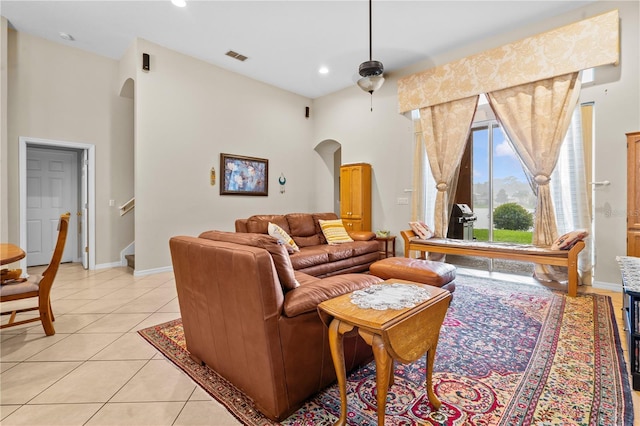 8804 Warwick Shore Xing Unit X, Orlando, FL 32829 - living room with arched walkways, light tile patterned floors, stairs, a towering ceiling, and recessed lighting