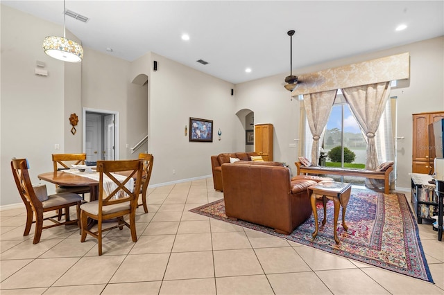 8804 Warwick Shore Xing Unit X, Orlando, FL 32829 - living area with arched walkways, light tile patterned floors, a high ceiling, and recessed lighting