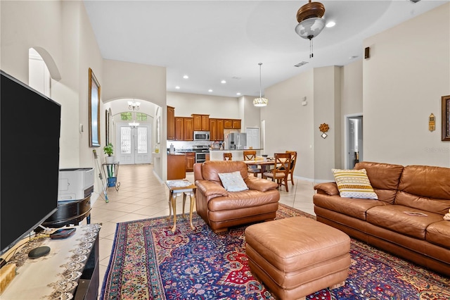 8804 Warwick Shore Xing Unit X, Orlando, FL 32829 - living room featuring light tile patterned flooring, a high ceiling, arched walkways, recessed lighting, and ceiling fan