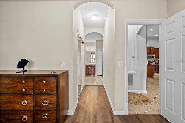 8804 Warwick Shore Xing Unit X, Orlando, FL 32829 - hall with arched walkways and light tile patterned floors