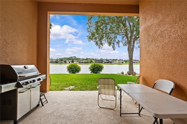 8804 Warwick Shore Xing Unit X, Orlando, FL 32829 - view of patio / terrace with a grill, a water view, and outdoor dining area