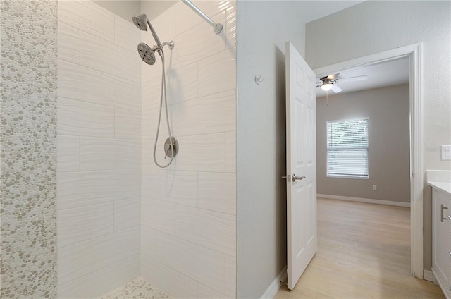 826 Camargo Way Unit 201, Altamonte Springs, FL 32714 - bathroom with a tile shower, a ceiling fan, vanity, and wood finished floors