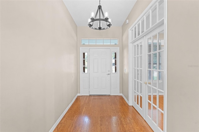 403 Courtlea Creek Dr, Winter Garden, FL 34787 - entryway featuring a chandelier, light wood-style floors, and french doors