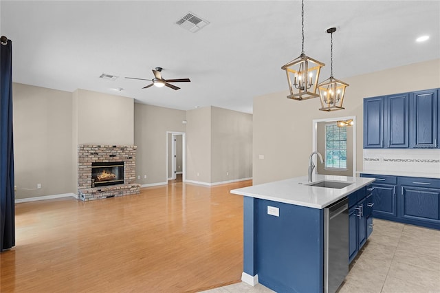 403 Courtlea Creek Dr, Winter Garden, FL 34787 - kitchen with blue cabinetry, dishwasher, a ceiling fan, light countertops, and a chandelier