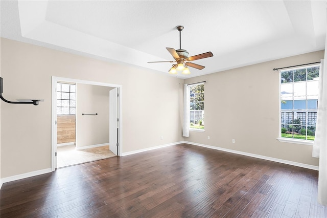403 Courtlea Creek Dr, Winter Garden, FL 34787 - spare room with healthy amount of natural light, a tray ceiling, and wood finished floors