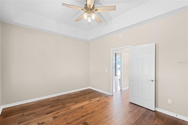403 Courtlea Creek Dr, Winter Garden, FL 34787 - spare room featuring a raised ceiling, wood-type flooring, and a ceiling fan