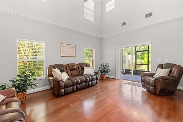 7348 Regina Way, Orlando, FL 32819 - living area with plenty of natural light, a towering ceiling, and wood finished floors