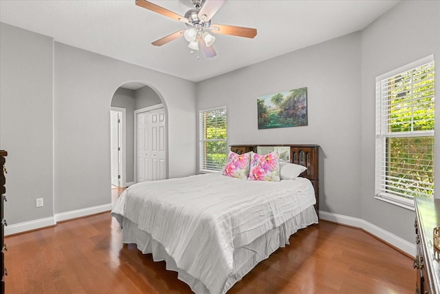 7348 Regina Way, Orlando, FL 32819 - bedroom with wood finished floors, multiple windows, and arched walkways
