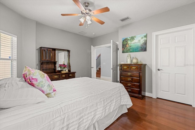 7348 Regina Way, Orlando, FL 32819 - bedroom with wood finished floors and a ceiling fan