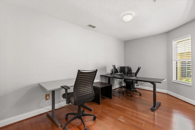 7348 Regina Way, Orlando, FL 32819 - home office featuring wood finished floors and a textured ceiling