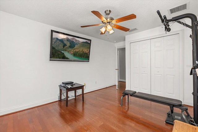 7348 Regina Way, Orlando, FL 32819 - workout area with wood finished floors and a ceiling fan
