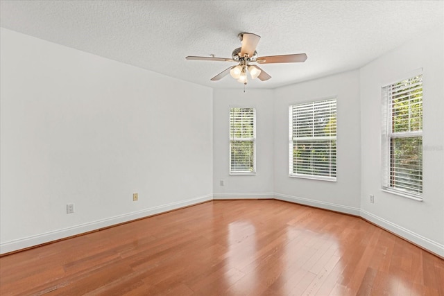 7348 Regina Way, Orlando, FL 32819 - unfurnished room featuring wood finished floors, ceiling fan, and a textured ceiling