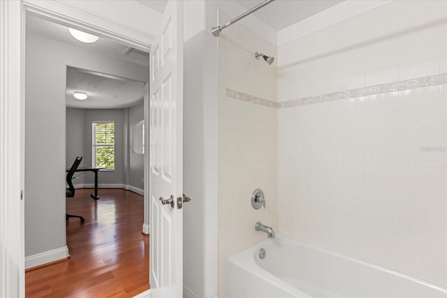 7348 Regina Way, Orlando, FL 32819 - bathroom with bathtub / shower combination, wood finished floors, and a textured ceiling