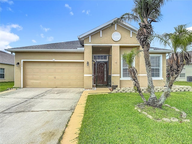 799 Hacienda Cir, Kissimmee, FL 34741 - view of front of property with driveway, stucco siding, a front lawn, and a garage