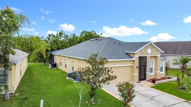 799 Hacienda Cir, Kissimmee, FL 34741 - view of front facade featuring stucco siding, concrete driveway, a front lawn, and a shingled roof