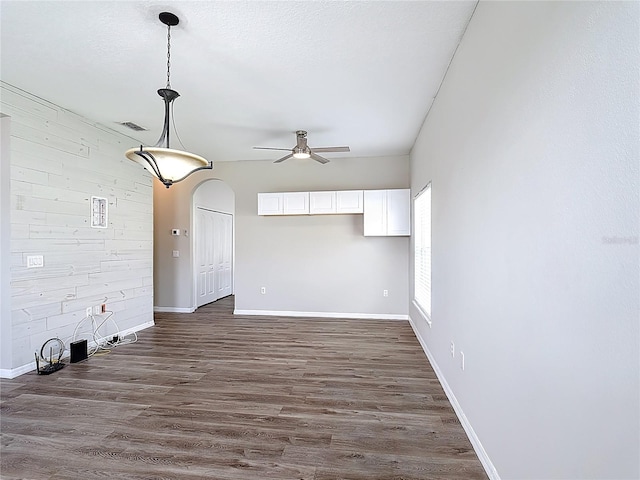 799 Hacienda Cir, Kissimmee, FL 34741 - unfurnished living room featuring a ceiling fan and dark wood-style flooring