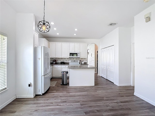 799 Hacienda Cir, Kissimmee, FL 34741 - kitchen featuring white appliances, recessed lighting, a kitchen island, dark wood-style flooring, and white cabinetry