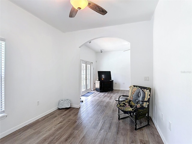 799 Hacienda Cir, Kissimmee, FL 34741 - sitting room with arched walkways, wood finished floors, a ceiling fan, and french doors