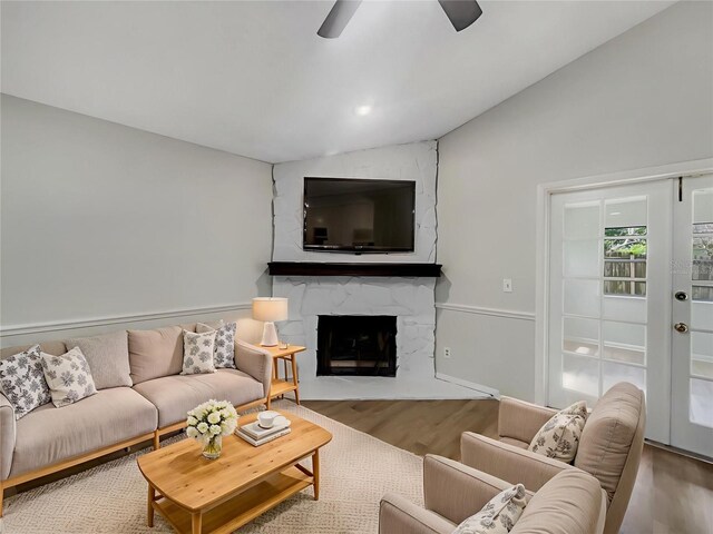 101 Whitley Bay Ln, Longwood, FL 32779 - living room featuring vaulted ceiling, wood finished floors, ceiling fan, and a fireplace