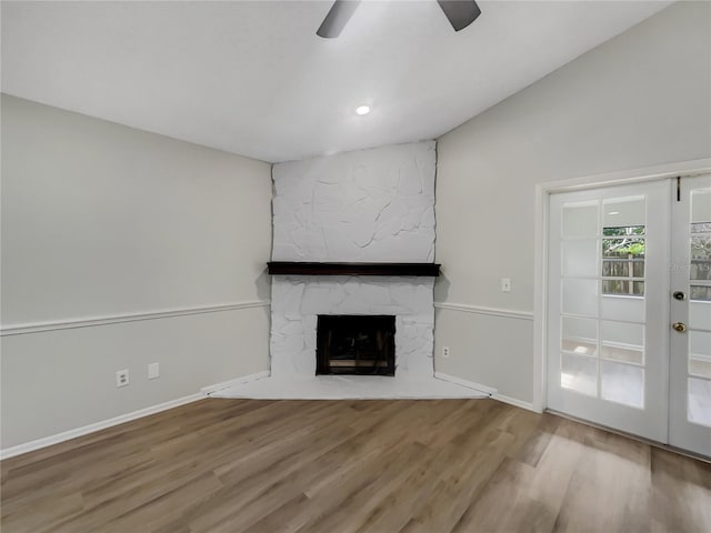 101 Whitley Bay Ln, Longwood, FL 32779 - unfurnished living room with wood finished floors, a stone fireplace, a ceiling fan, and recessed lighting