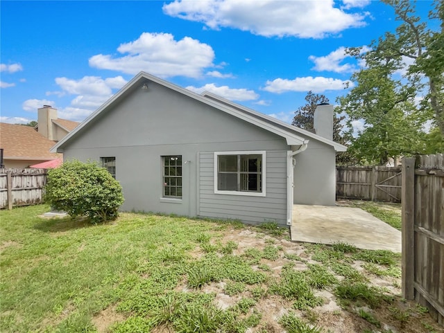 101 Whitley Bay Ln, Longwood, FL 32779 - rear view of house with a chimney, a fenced backyard, a patio, and stucco siding