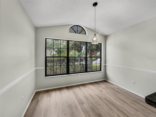 101 Whitley Bay Ln, Longwood, FL 32779 - unfurnished dining area with lofted ceiling, a textured ceiling, and wood finished floors