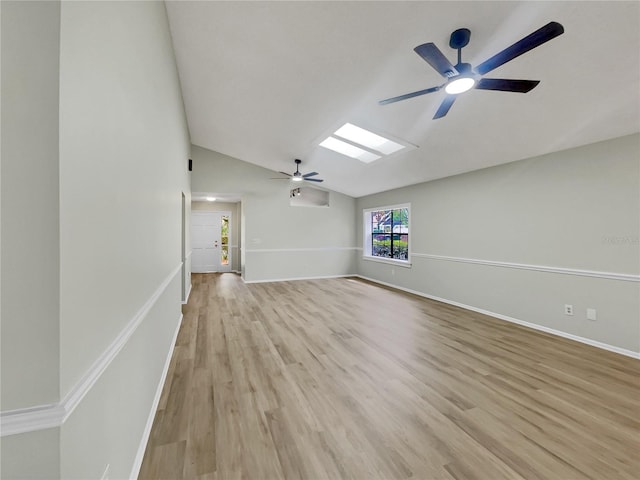 101 Whitley Bay Ln, Longwood, FL 32779 - unfurnished living room featuring ceiling fan, lofted ceiling, light wood-style flooring, and a skylight