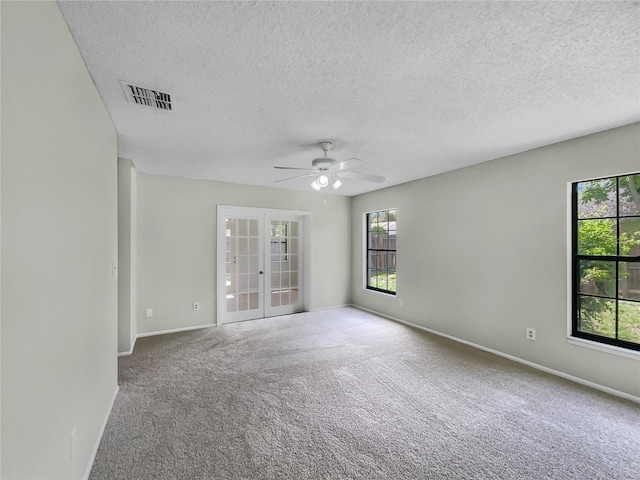 101 Whitley Bay Ln, Longwood, FL 32779 - spare room with a ceiling fan, french doors, carpet floors, and a textured ceiling