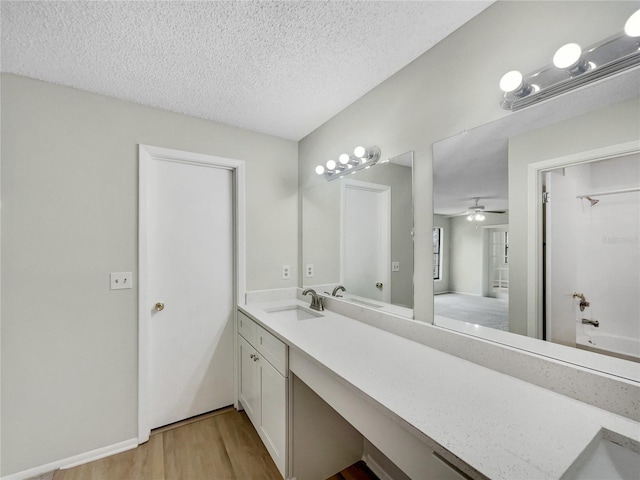 101 Whitley Bay Ln, Longwood, FL 32779 - full bath featuring vanity, wood finished floors, a textured ceiling, a ceiling fan, and shower / washtub combination
