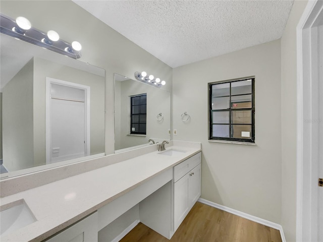 101 Whitley Bay Ln, Longwood, FL 32779 - full bath featuring wood finished floors, double vanity, and a textured ceiling
