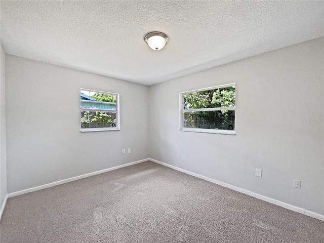 2607 Castle Oak Ave, Orlando, FL 32808 - carpeted spare room with a textured ceiling and baseboards