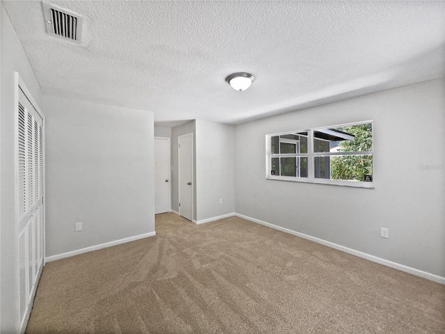 2607 Castle Oak Ave, Orlando, FL 32808 - unfurnished bedroom with carpet flooring and a textured ceiling