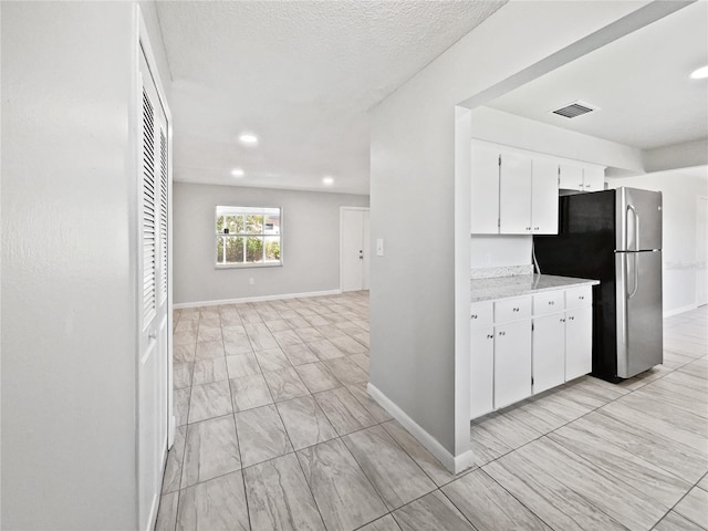 2607 Castle Oak Ave, Orlando, FL 32808 - kitchen featuring freestanding refrigerator, light countertops, white cabinets, recessed lighting, and open floor plan