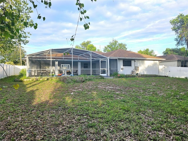 2010 Appian Ct, Deltona, FL 32725 - back of property with a fenced backyard and glass enclosure