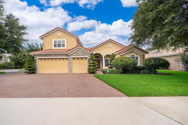 2258 Rickover Pl, Winter Garden, FL 34787 - view of front of house featuring stone siding, decorative driveway, stucco siding, a front lawn, and a tiled roof
