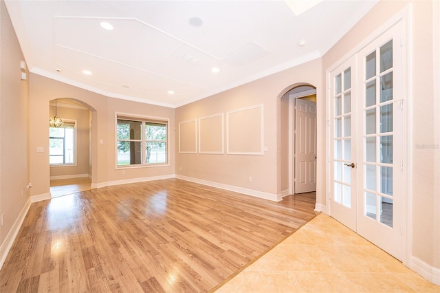 2258 Rickover Pl, Winter Garden, FL 34787 - spare room with arched walkways, ornamental molding, light wood-style flooring, french doors, and recessed lighting