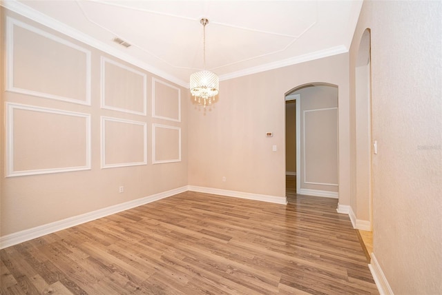 2258 Rickover Pl, Winter Garden, FL 34787 - empty room featuring arched walkways, light wood-type flooring, a chandelier, and ornamental molding