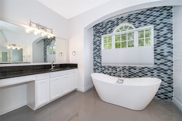 2258 Rickover Pl, Winter Garden, FL 34787 - full bath featuring a freestanding tub, plenty of natural light, vanity, tile patterned flooring, and tile walls