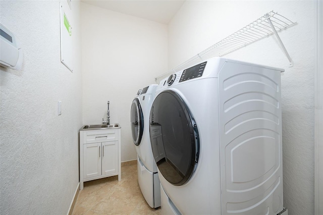 2258 Rickover Pl, Winter Garden, FL 34787 - laundry room with separate washer and dryer, a textured wall, and cabinet space