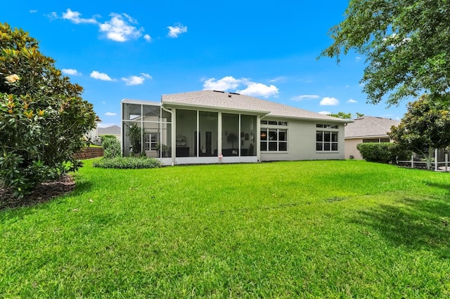 785 Hawks Blf, Clermont, FL 34711 - back of house with a sunroom, a yard, and stucco siding