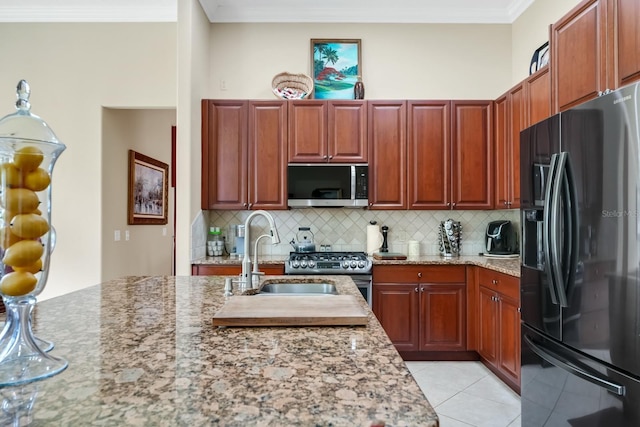785 Hawks Blf, Clermont, FL 34711 - kitchen featuring appliances with stainless steel finishes, crown molding, tasteful backsplash, light stone countertops, and light tile patterned floors