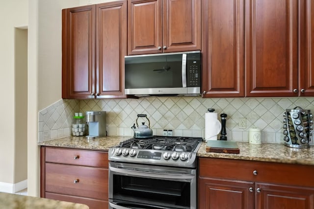 785 Hawks Blf, Clermont, FL 34711 - kitchen with appliances with stainless steel finishes, decorative backsplash, light stone countertops, and reddish brown cabinets