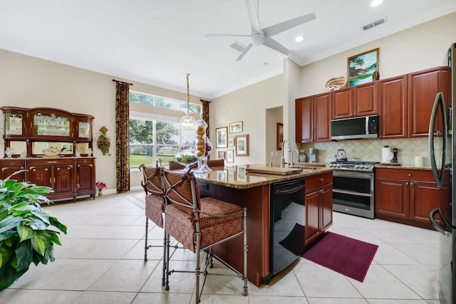 785 Hawks Blf, Clermont, FL 34711 - kitchen featuring appliances with stainless steel finishes, stone countertops, light tile patterned floors, backsplash, and ceiling fan